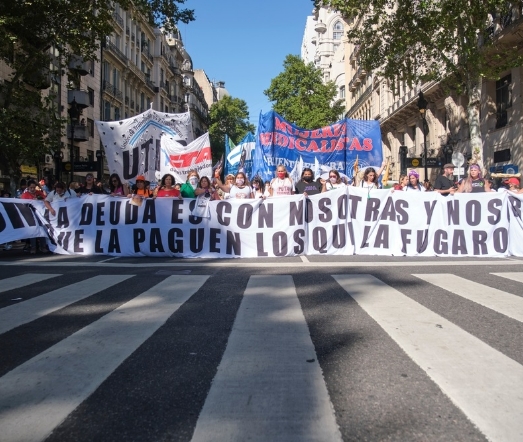 Argentina Protesters hold a banner reading: "The debt is with us, let those whose capital fled pay." Credit: Carolina Jaramillo/ Shutterstock