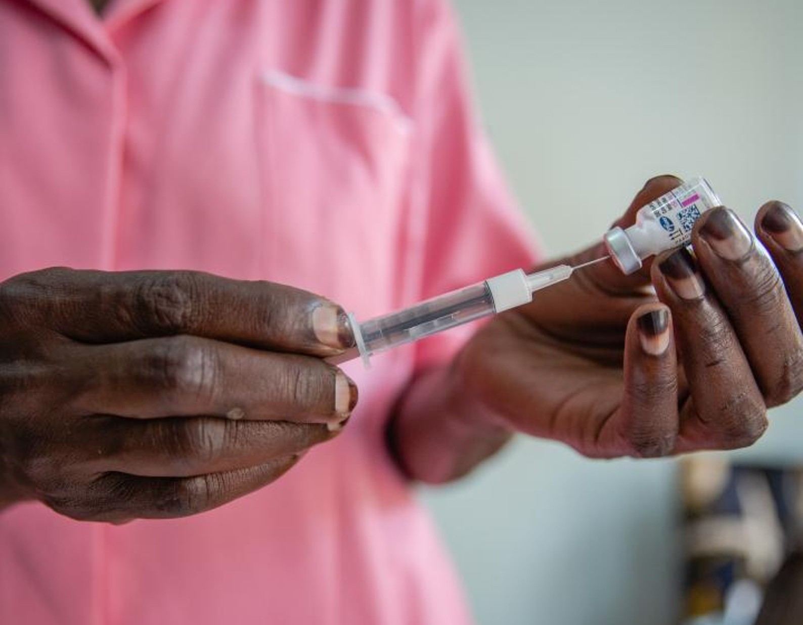 Nurse Margaret gives an injection to a client at Kawala Health Center IV in Uganda - Action Aid report